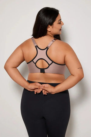 Close-up of beige underwired sports bra neckline with black contrast piping and molded cup shape - MissFine