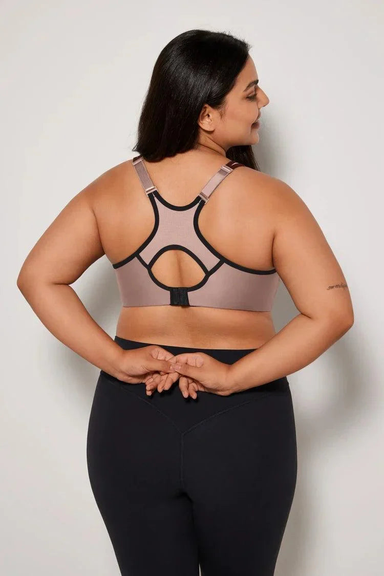 Close-up of beige underwired sports bra neckline with black contrast piping and molded cup shape - MissFine