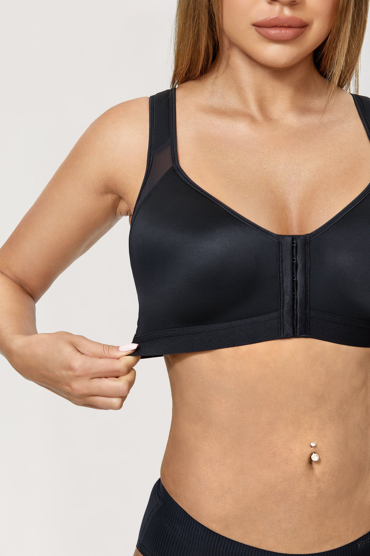 A patented bra that closes in front for an orthopedic grip on the back